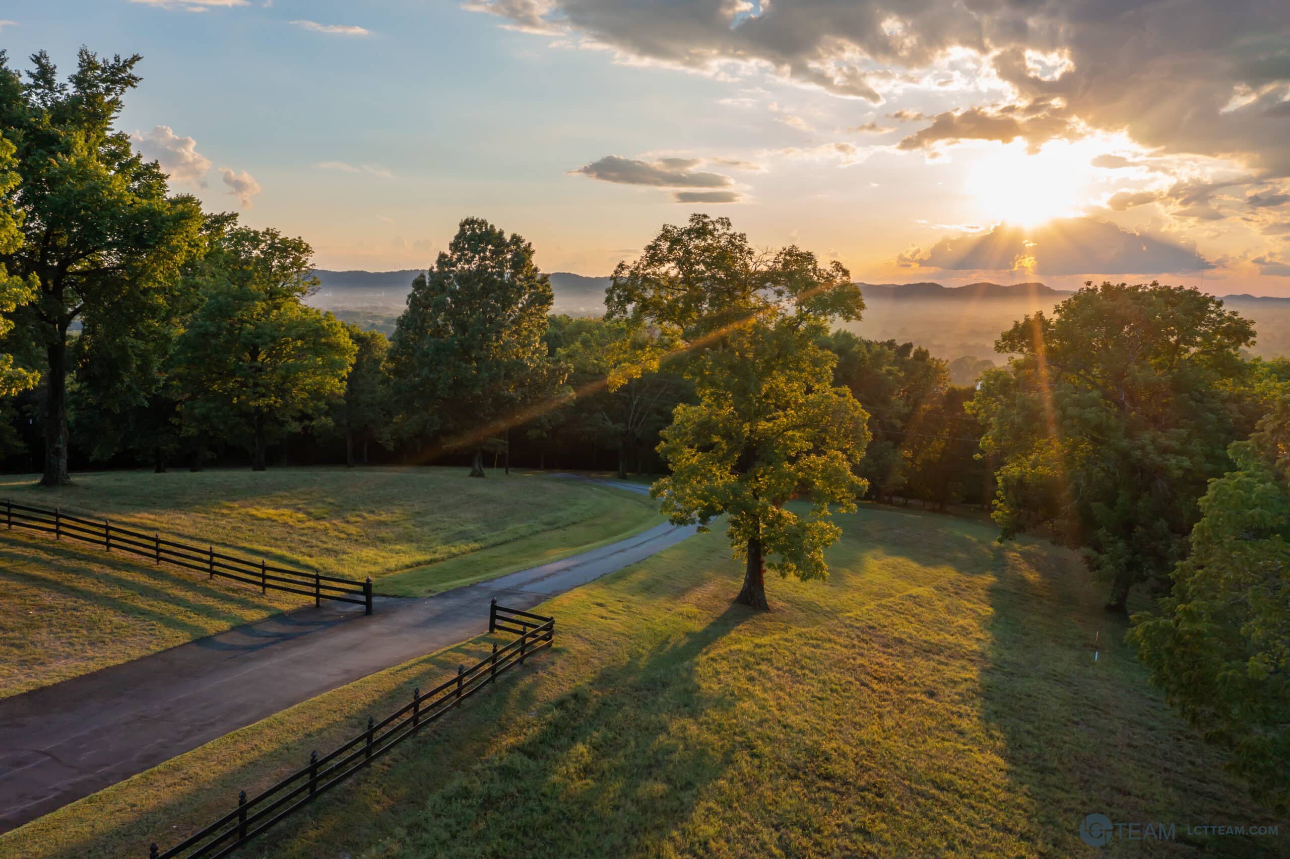 A gated road at sunset