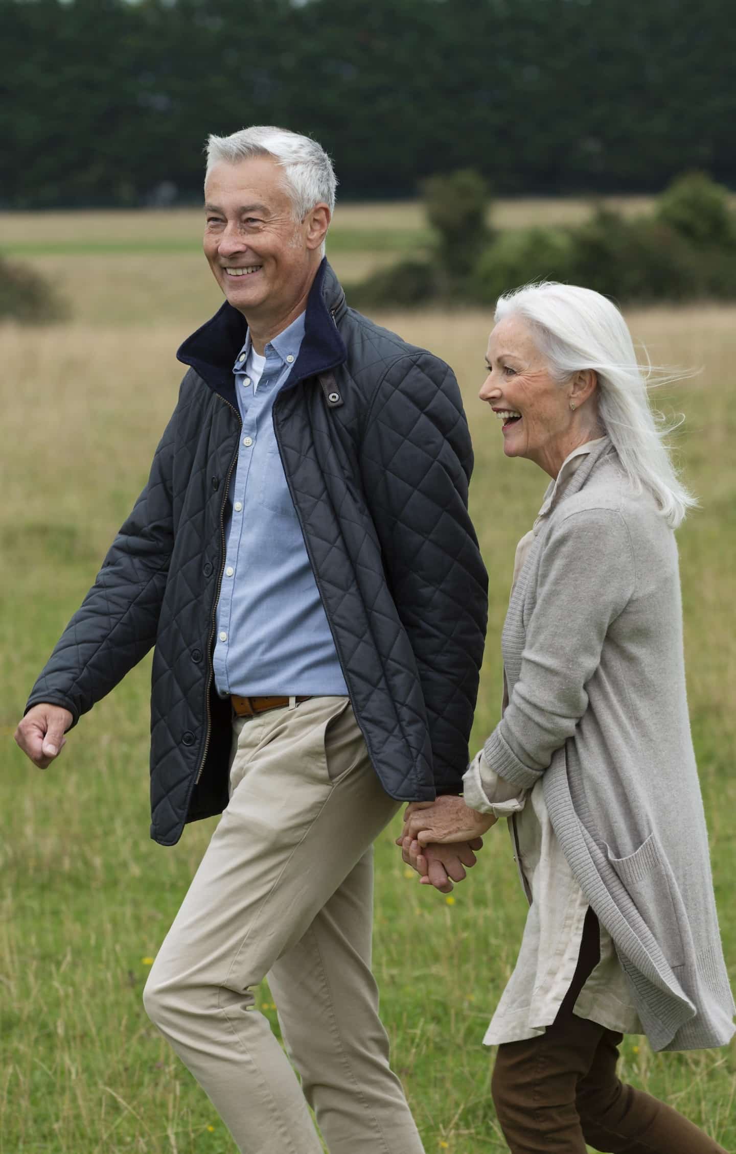 adorable-senior-couple-being-affectionate-while-taking-walk An elderly couple walking on farmland