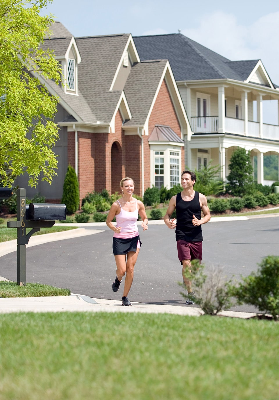 Two people running in a neighborhood